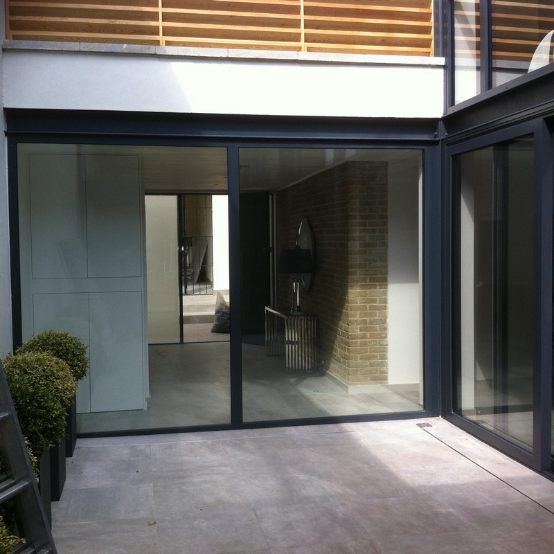 Floor-to-ceiling sliding doors opening to courtyard in Wolverton